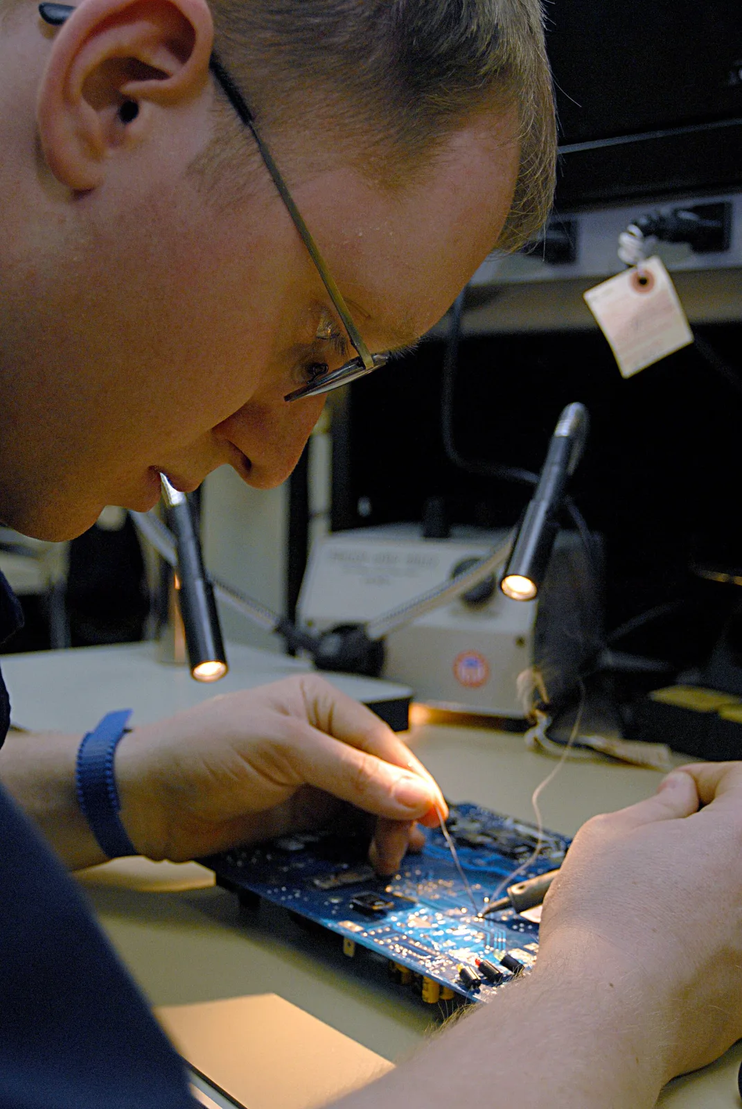 Technician soldering a circuit board