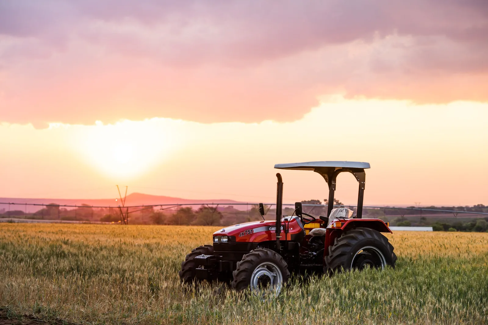 Tractor in a field at sunset